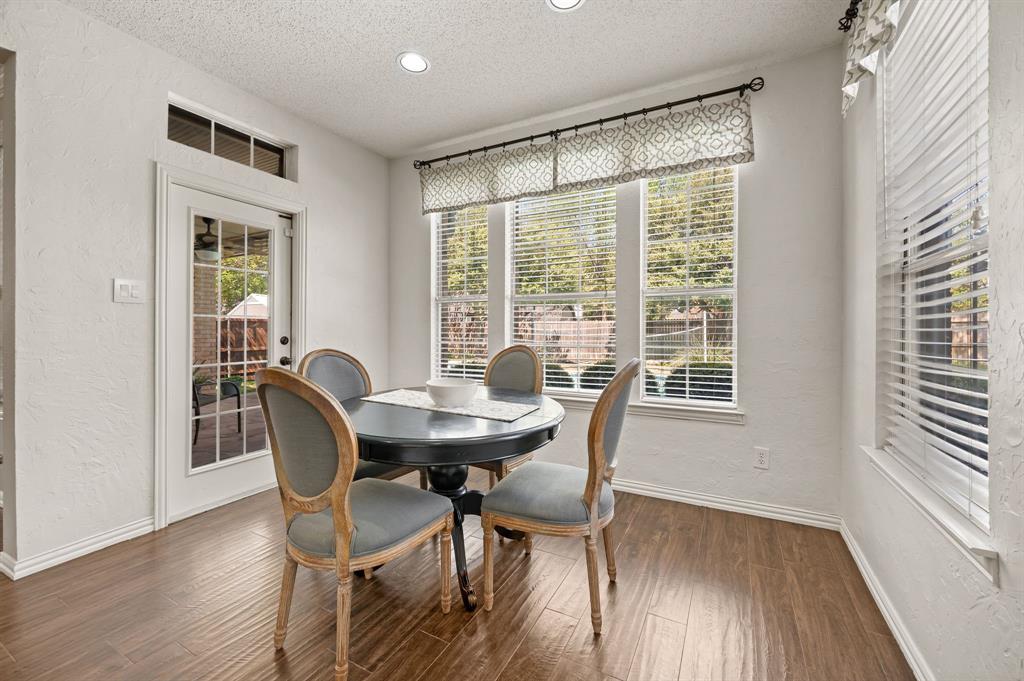 417 Shade Tree Circle Hurst, TX 76054 - Photo 14 of 39 a view of a dining room with furniture and wooden floor