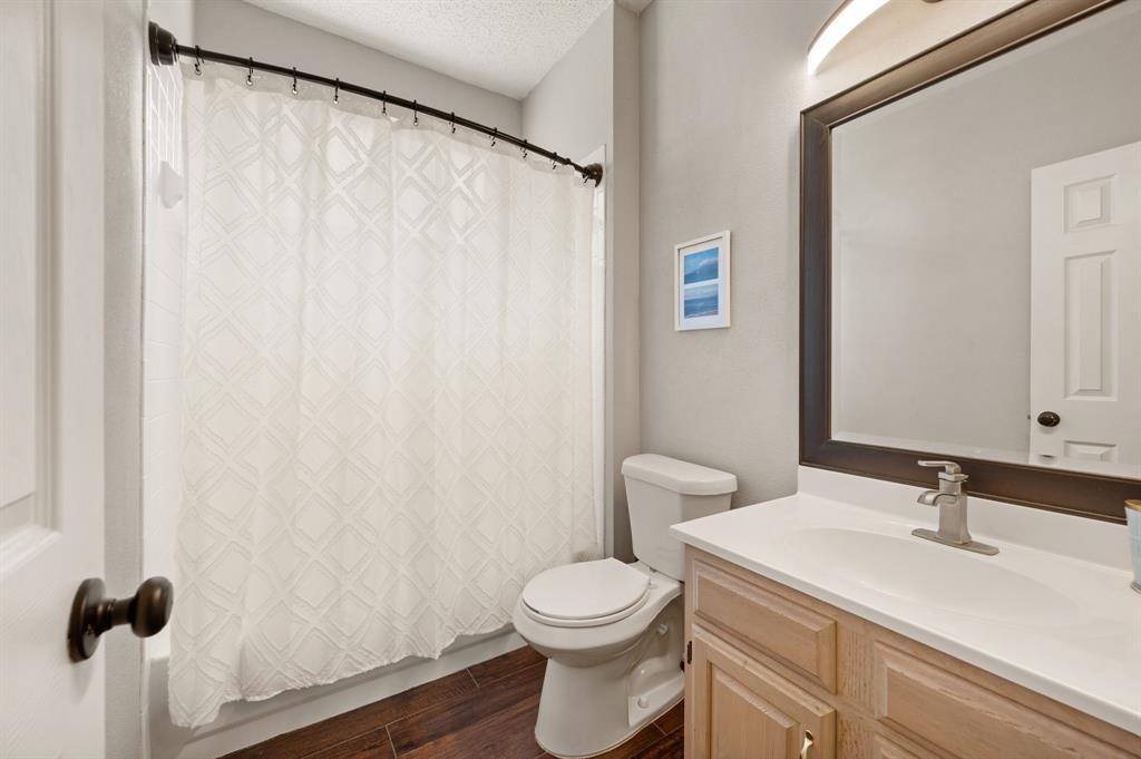 417 Shade Tree Circle Hurst, TX 76054 - Photo 15 of 39 a bathroom with a sink a toilet and a mirror
