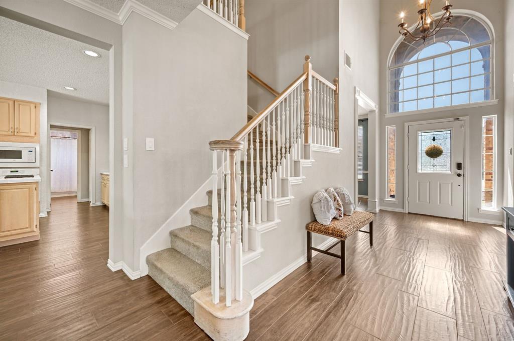 417 Shade Tree Circle Hurst, TX 76054 - Photo 17 of 39 a view of entryway with wooden floor and stairs