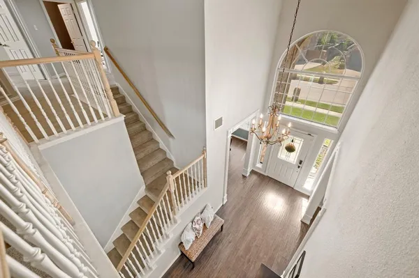 a bedroom with a large bed and a chandelier