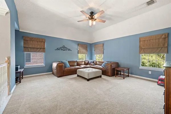 a spacious bathroom with a granite countertop sink a mirror a bathtub and next to a window