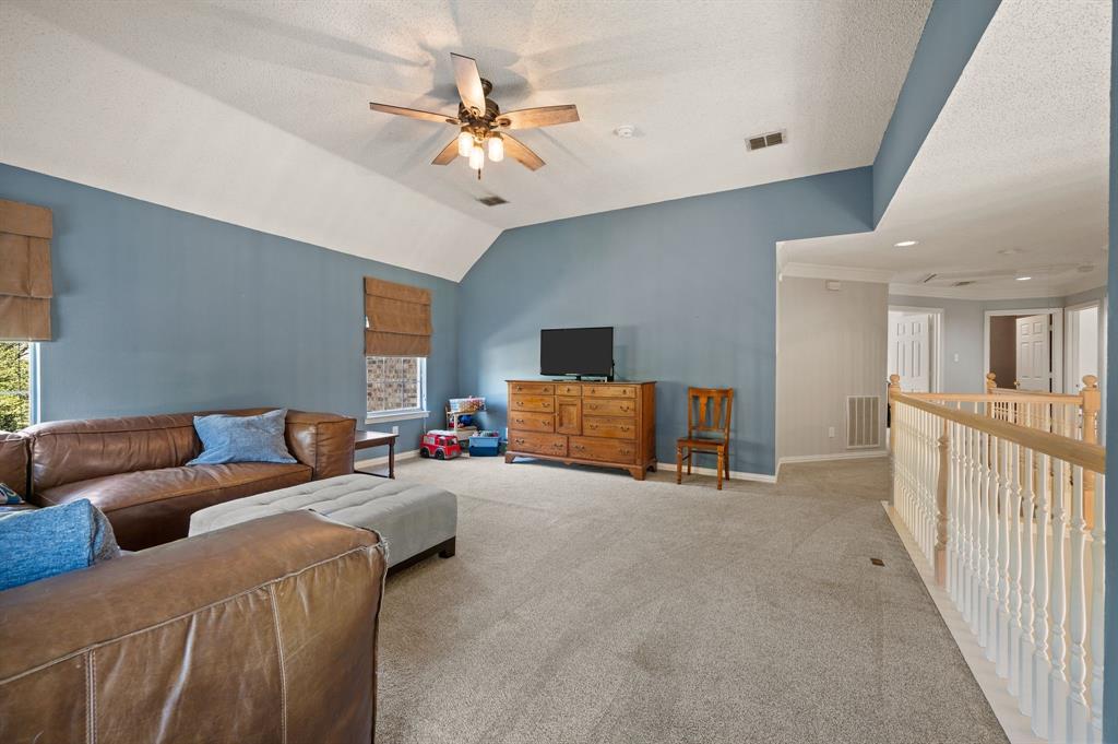 417 Shade Tree Circle Hurst, TX 76054 - Photo 20 of 39 a living room with furniture and a chandelier