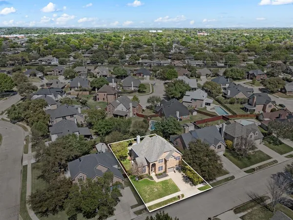 a view of a swimming pool with a lounge chair and trees in the background