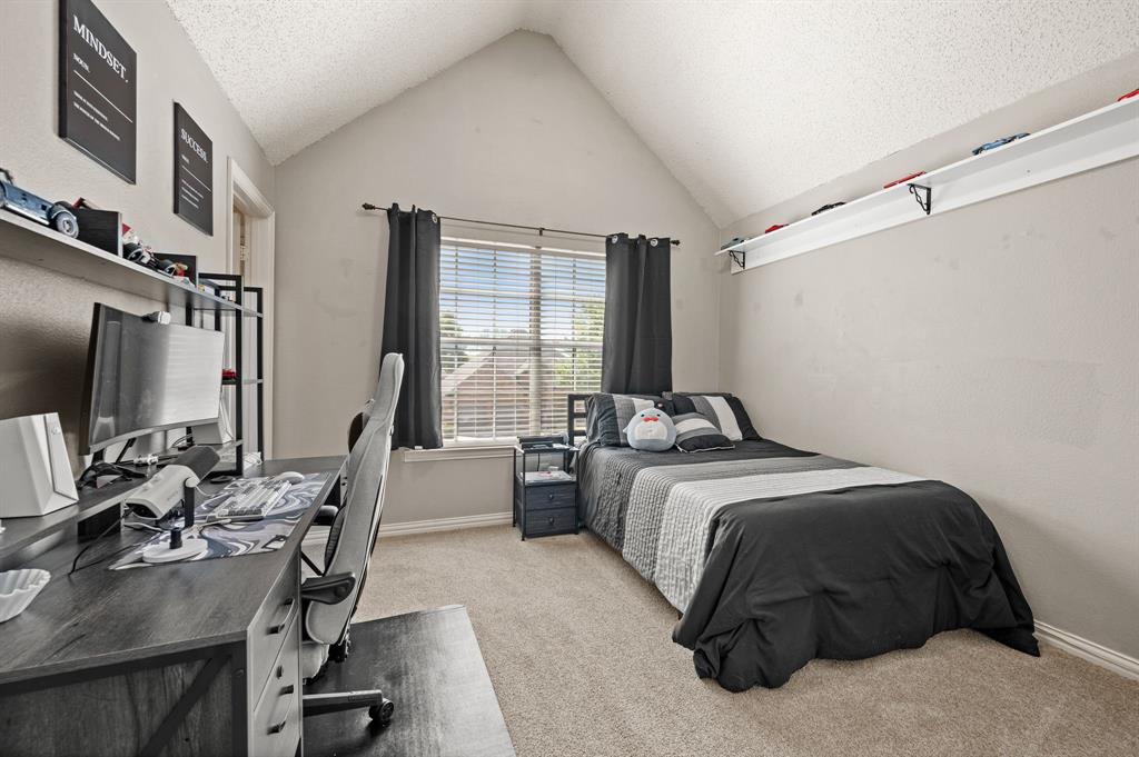 417 Shade Tree Circle Hurst, TX 76054 - Photo 27 of 39 a bedroom with a bed flat screen tv and a large window