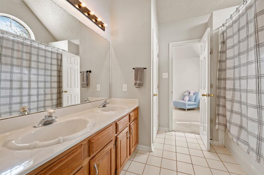 417 Shade Tree Circle Hurst, TX 76054 - Photo 28 of 39 a spacious bathroom with a sink a toilet and shower