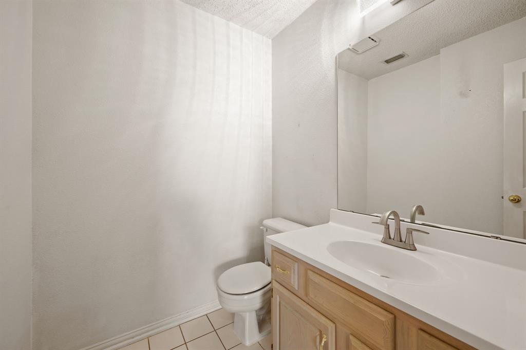 417 Shade Tree Circle Hurst, TX 76054 - Photo 30 of 39 a bathroom with a sink toilet and vanity