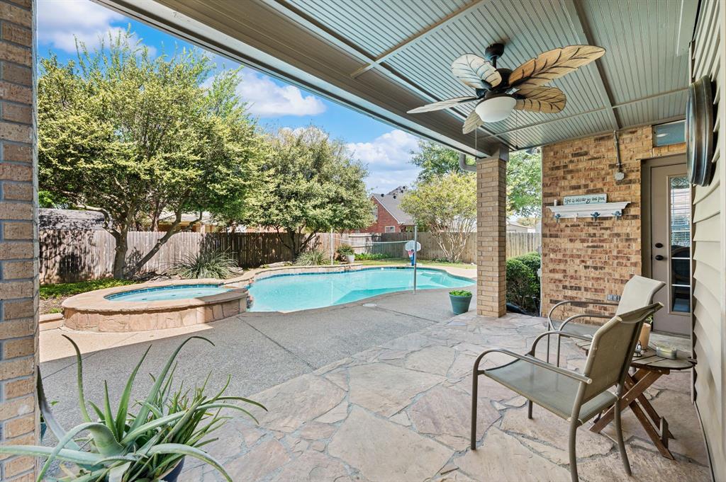417 Shade Tree Circle Hurst, TX 76054 - Photo 31 of 39 a view of a patio with table and chairs and potted plants