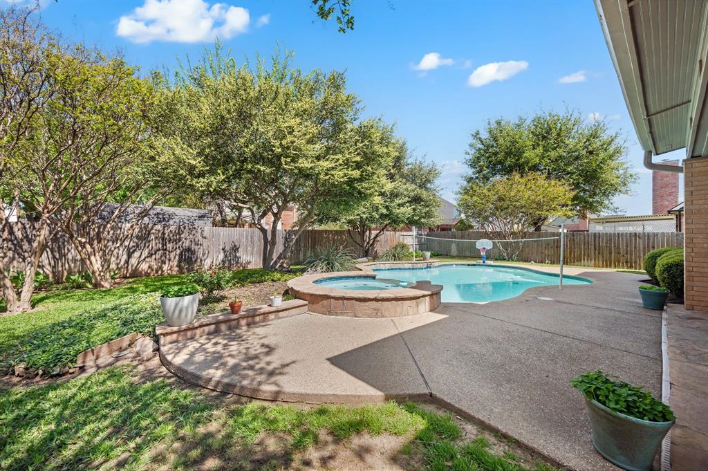 417 Shade Tree Circle Hurst, TX 76054 - Photo 32 of 39 a view of a patio with table and chairs and potted plants