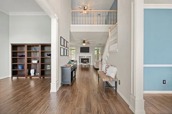 a living room with furniture a fireplace and a flat screen tv