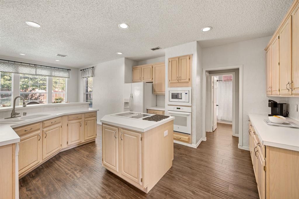417 Shade Tree Circle Hurst, TX 76054 - Photo 10 of 39 a kitchen with a stove a sink a refrigerator and a oven