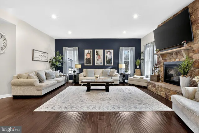 a view of a dining room and livingroom with furniture a chandelier and wooden floor