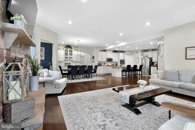 a bathroom with a granite countertop sink a toilet and a shower