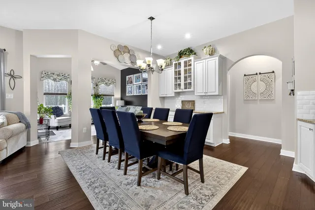a bathroom with a granite countertop toilet a sink and a mirror