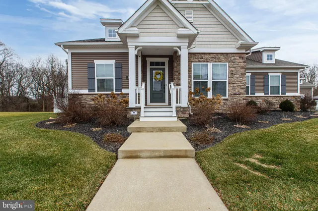 a view of a livingroom with workspace and a window
