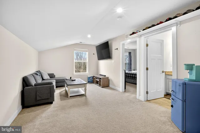 a view of a house with a table and chairs in patio