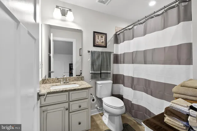 a front view of a house with a garden and plants