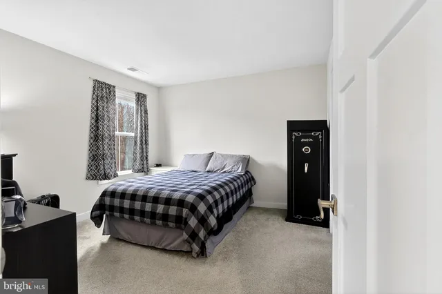 a view of a house with a small yard and sitting area