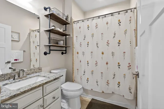 a bedroom with a bed and a tv on the dresser
