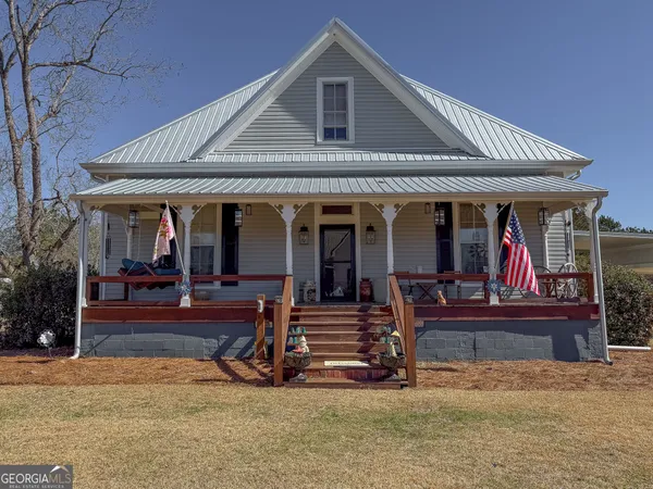 an aerial view of a house with a yard