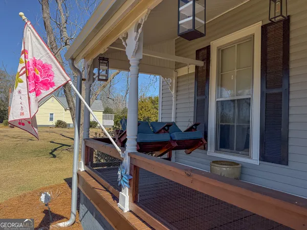 a view of a balcony with chairs and wooden floor