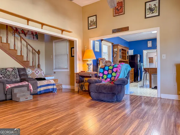 a kitchen with stainless steel appliances granite countertop a refrigerator a stove top oven a sink dishwasher and wooden cabinets with wooden floor