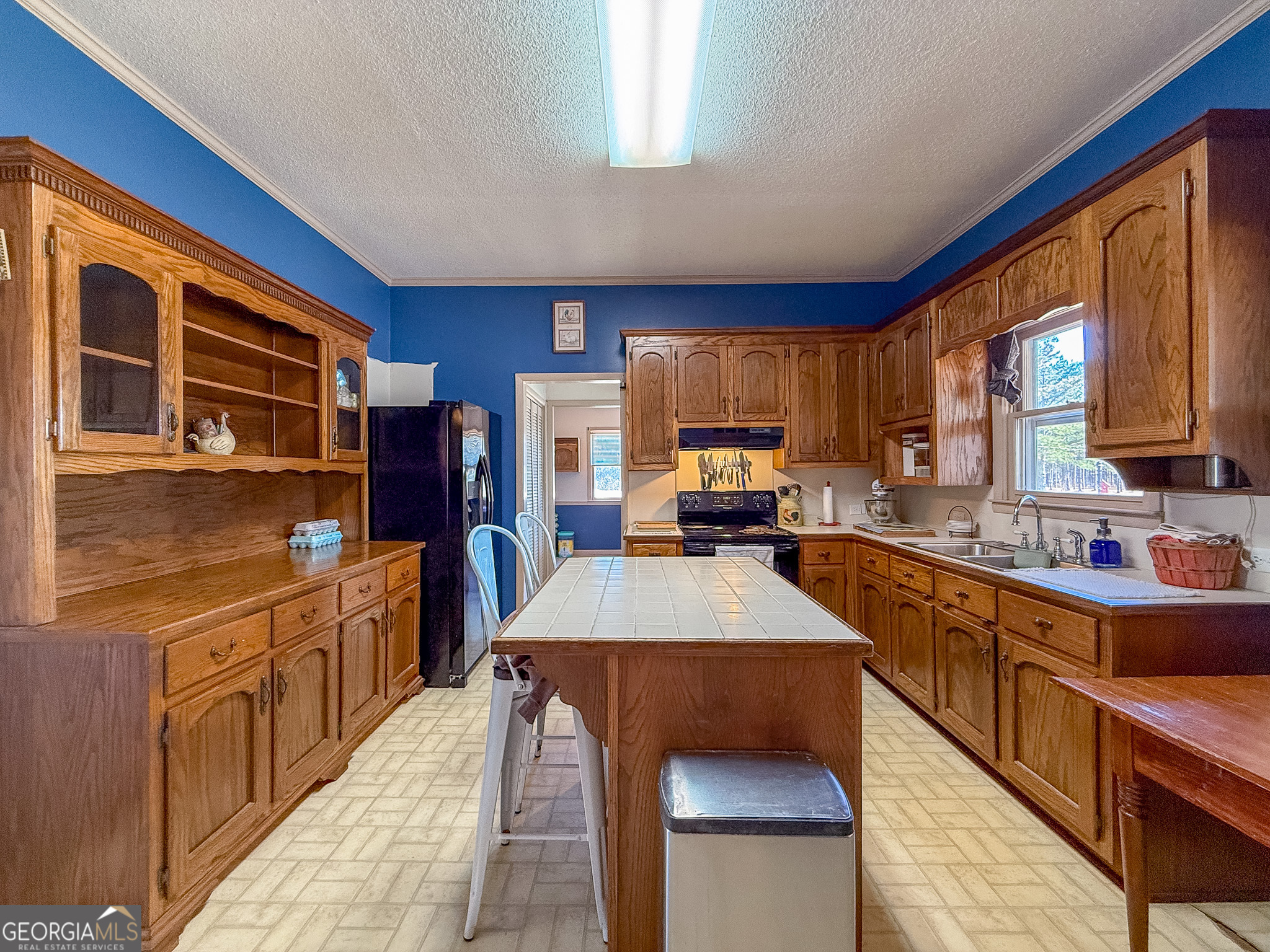 162 College Street Parrott, GA 39877 - Photo 10 of 30 a kitchen with stainless steel appliances granite countertop a refrigerator a stove top oven a sink dishwasher and wooden cabinets with wooden floor