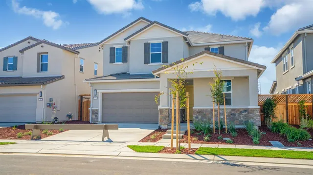 a view of a house with a yard and plants