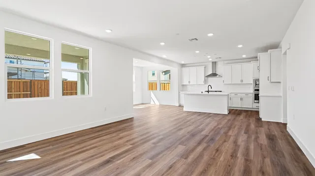 a view of kitchen with wooden floor and electronic appliances
