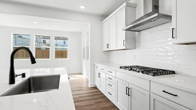 a kitchen with granite countertop a stove and a sink