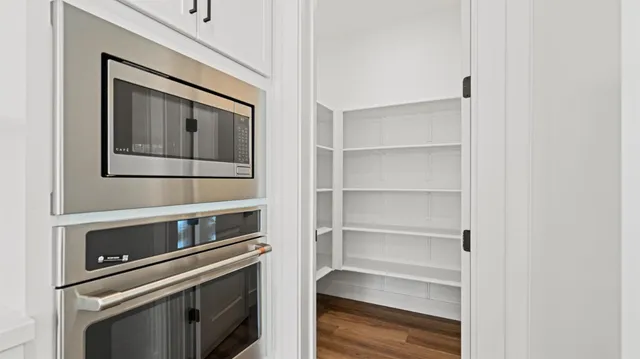 a kitchen with white cabinets and a stove