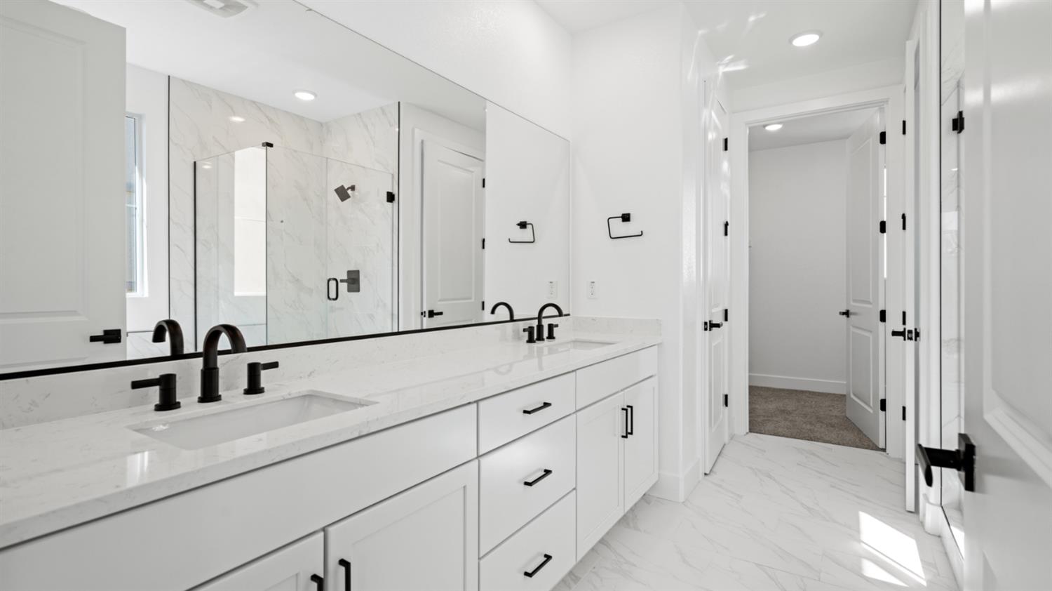770 Lorca Street Mountain House, CA 95391 - Photo 27 of 38 a bathroom with double vanity sink and mirror with shower