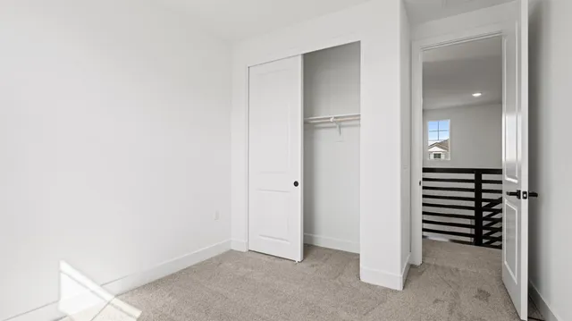 an empty room with a closet and mirror