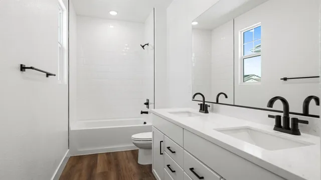 a bathroom with a sink toilet tub and shower