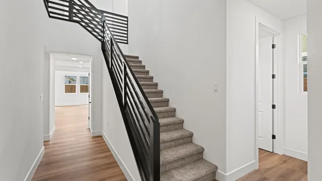 a view of a hallway with wooden floor and entryway