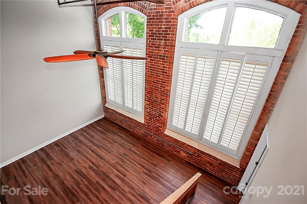 201 South Hoskins Road, Unit 237 Charlotte, NC 28208 - Photo 2 of 46 a view of an empty room with wooden floor and a window