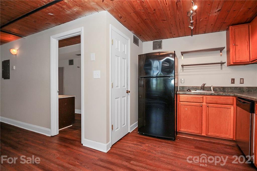 201 South Hoskins Road, Unit 237 Charlotte, NC 28208 - Photo 11 of 46 a kitchen with stainless steel appliances granite countertop a refrigerator and a sink