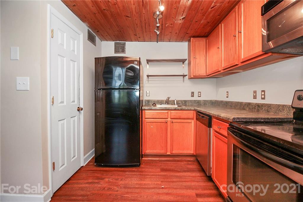 201 South Hoskins Road, Unit 237 Charlotte, NC 28208 - Photo 12 of 46 a kitchen with stainless steel appliances granite countertop a refrigerator stove and sink