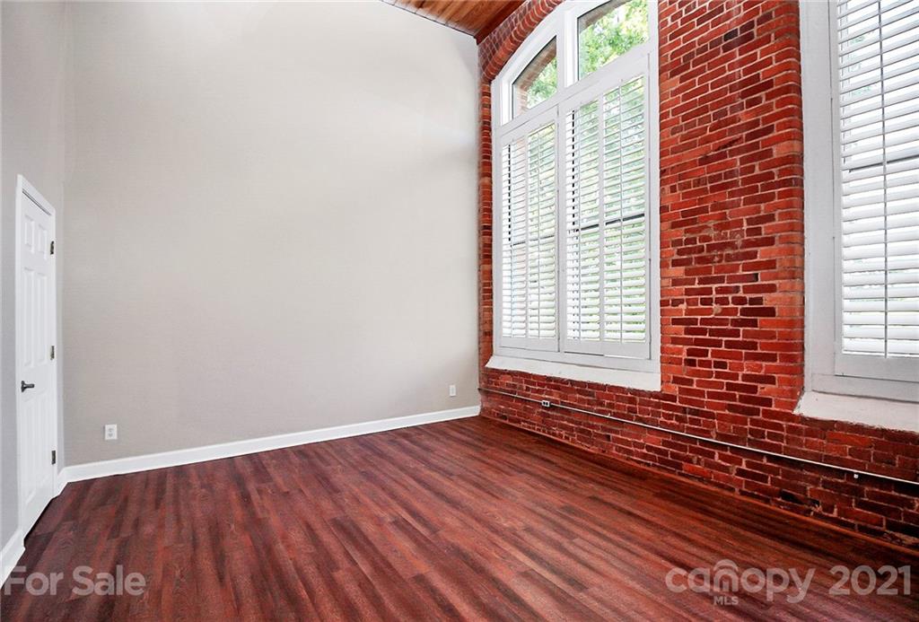 201 South Hoskins Road, Unit 237 Charlotte, NC 28208 - Photo 16 of 46 a view of an empty room with wooden floor and a window