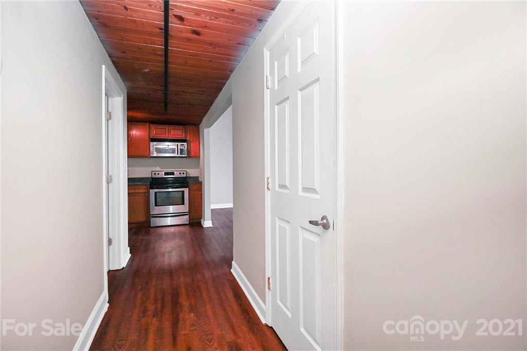 201 South Hoskins Road, Unit 237 Charlotte, NC 28208 - Photo 3 of 46 a view of a hallway with wooden floor