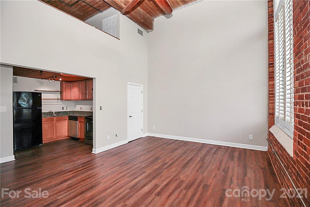 201 South Hoskins Road, Unit 237 Charlotte, NC 28208 - Photo 21 of 46 a view of a kitchen with wooden floor and a kitchen