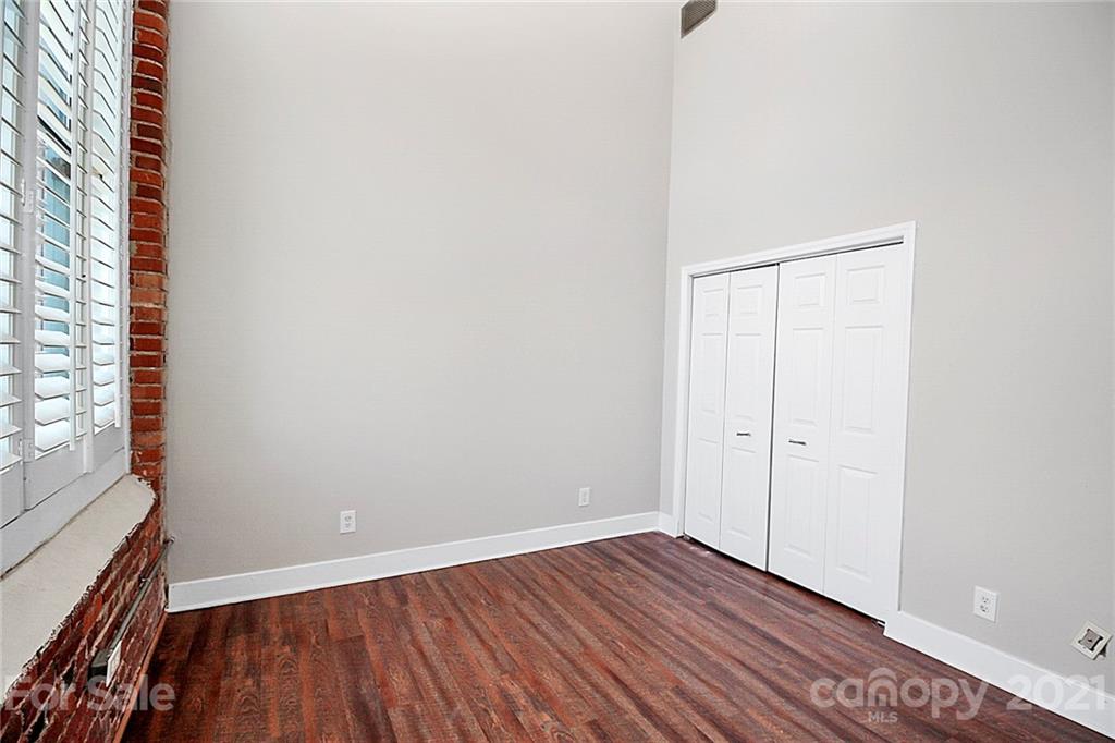 201 South Hoskins Road, Unit 237 Charlotte, NC 28208 - Photo 23 of 46 a view of an empty room with wooden floor and a window
