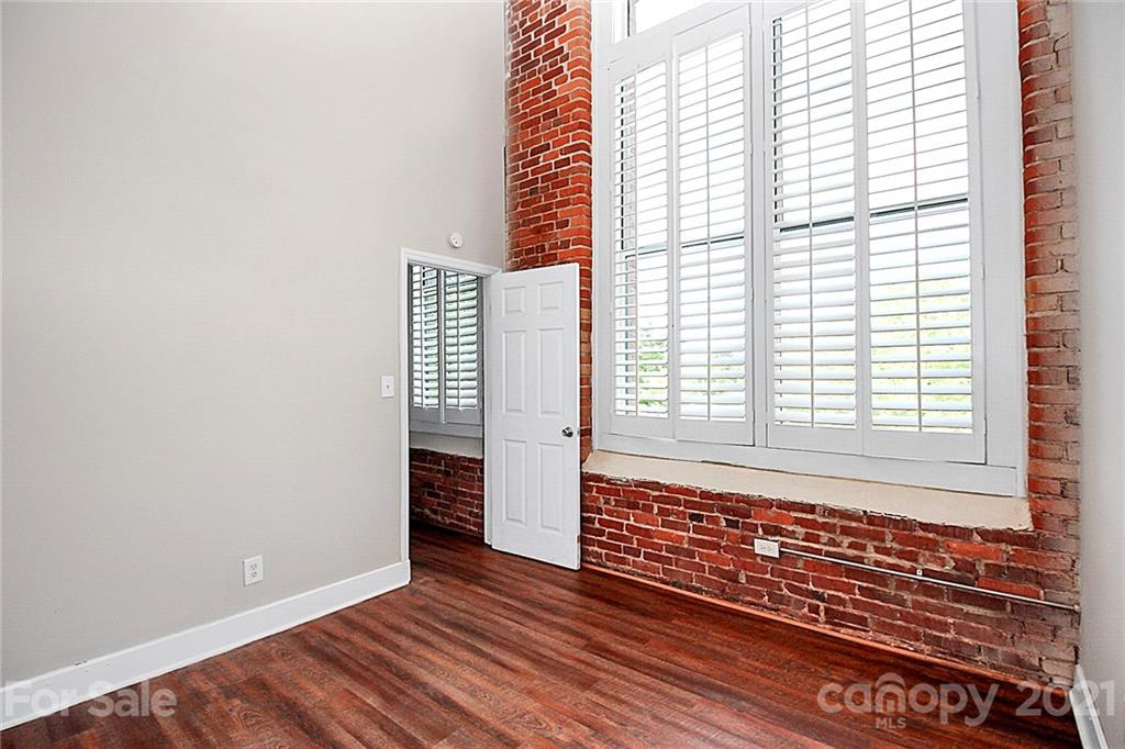 201 South Hoskins Road, Unit 237 Charlotte, NC 28208 - Photo 25 of 46 a view of an empty room with wooden floor and a window