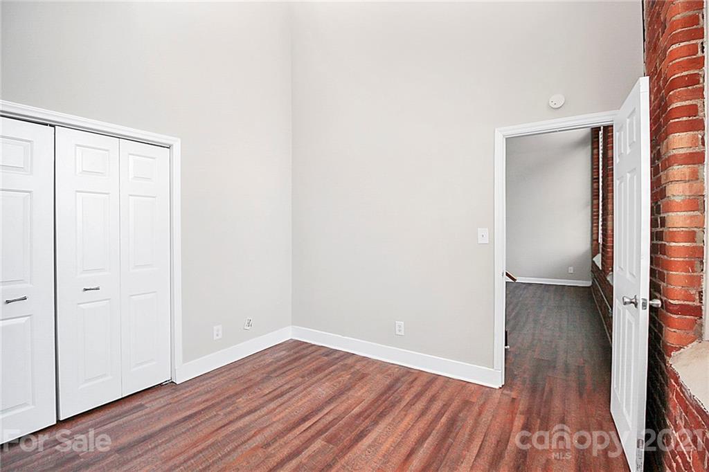 201 South Hoskins Road, Unit 237 Charlotte, NC 28208 - Photo 26 of 46 a view of a room with wooden floor and a window