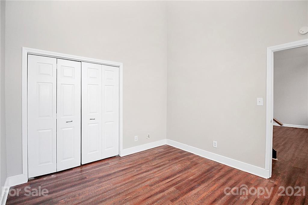 201 South Hoskins Road, Unit 237 Charlotte, NC 28208 - Photo 27 of 46 a view of an empty room with wooden floor