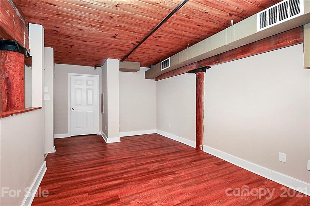 201 South Hoskins Road, Unit 237 Charlotte, NC 28208 - Photo 33 of 46 a view of an empty room with wooden floor