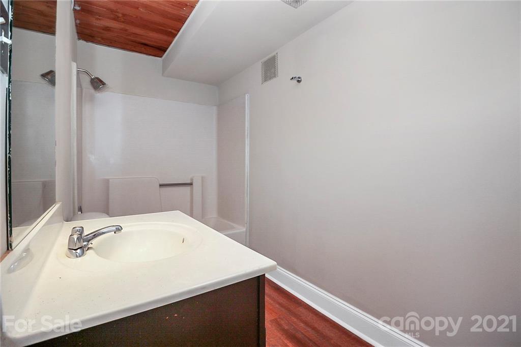 201 South Hoskins Road, Unit 237 Charlotte, NC 28208 - Photo 5 of 46 a bathroom with a sink and a vanity