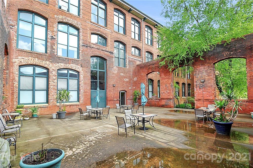 201 South Hoskins Road, Unit 237 Charlotte, NC 28208 - Photo 42 of 46 a building outdoor space with lots of furniture and plants