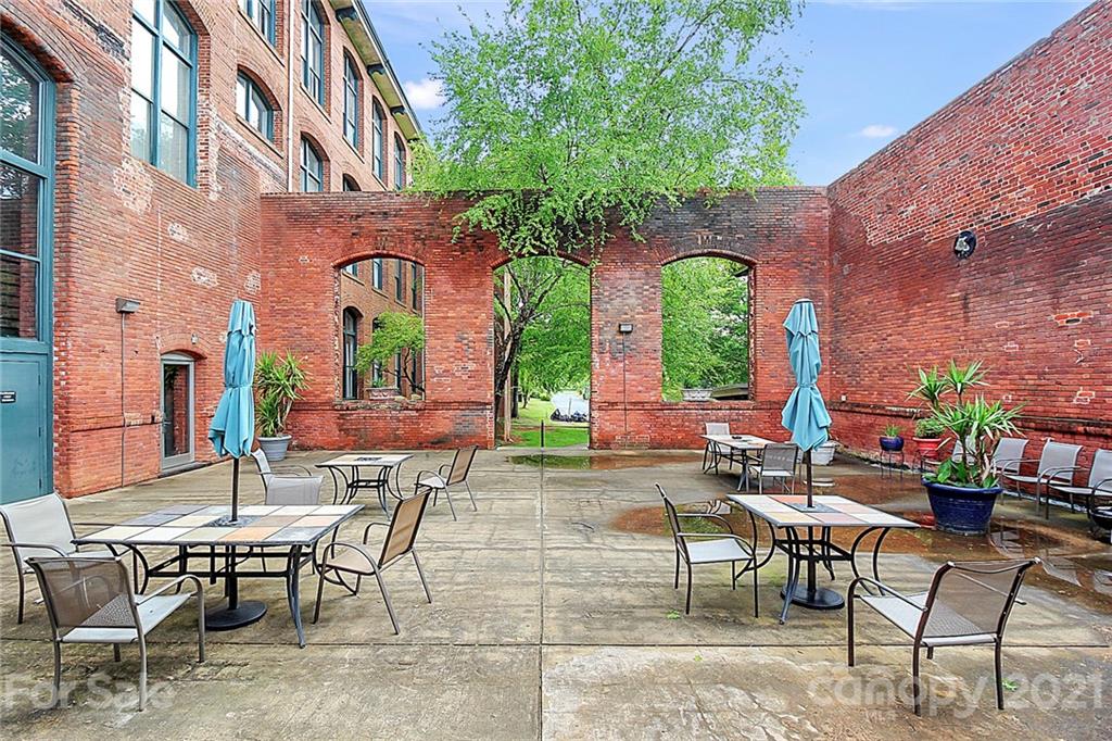 201 South Hoskins Road, Unit 237 Charlotte, NC 28208 - Photo 43 of 46 a view of a chairs and table in a patio