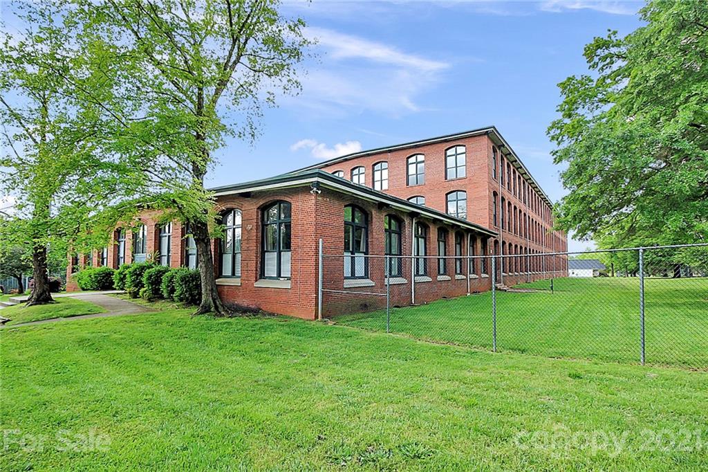 201 South Hoskins Road, Unit 237 Charlotte, NC 28208 - Photo 45 of 46 a view of a house with a big yard and large trees