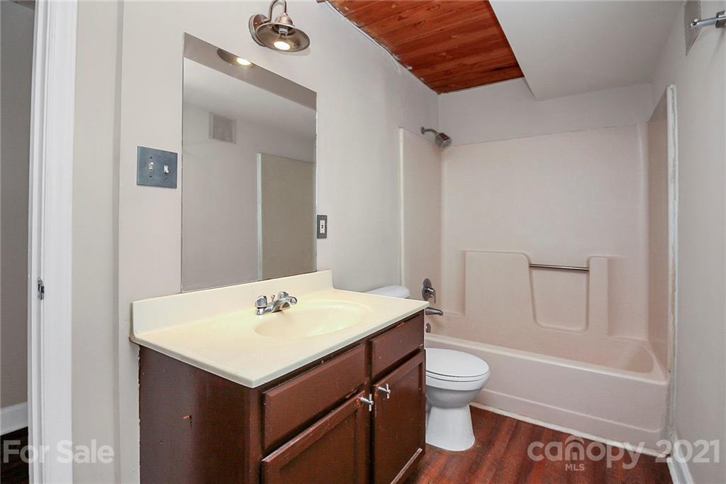 201 South Hoskins Road, Unit 237 Charlotte, NC 28208 - Photo 6 of 46 a bathroom with a sink a toilet and shower